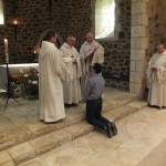 le père abbé s'adresse au postulant et le maitre des novices tient l'habit dans ses mains